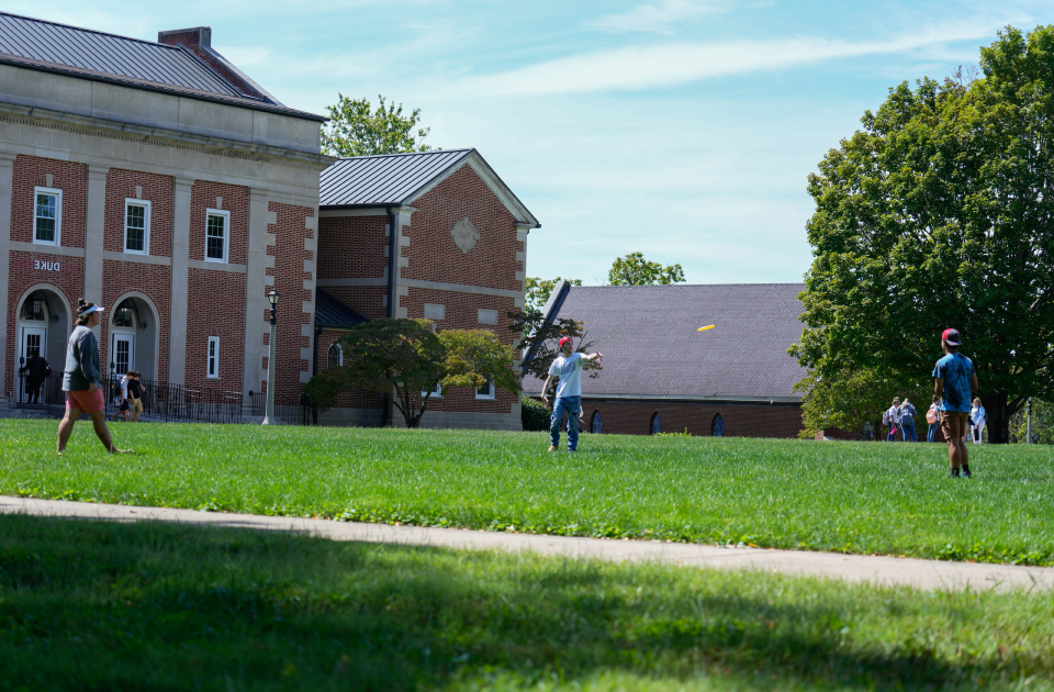 A group of students playing frisbee.